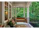 Inviting front porch with hanging swing, wicker furniture, and serene view of the surrounding greenery at 508 Hastings Dr, Peachtree City, GA 30269