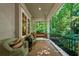 Inviting front porch with wicker chairs and a swing, perfect for relaxing outdoors at 508 Hastings Dr, Peachtree City, GA 30269
