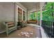 Inviting front porch with a swing and wicker chairs offers relaxation and a view of nature at 508 Hastings Dr, Peachtree City, GA 30269