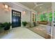 Charming front porch with a swing, wicker chairs, and stylish lighting fixtures at 508 Hastings Dr, Peachtree City, GA 30269