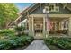 Inviting front porch with swing, wicker seating, and view of the landscaped yard at 508 Hastings Dr, Peachtree City, GA 30269