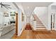 Hardwood hallway leading to the staircase and living room with fireplace and built-ins at 508 Hastings Dr, Peachtree City, GA 30269