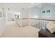 Bright hallway with white railings, natural light and hardwood floors at 508 Hastings Dr, Peachtree City, GA 30269