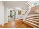 Inviting hallway with hardwood floors and staircase, offering a glimpse into a cozy living room at 508 Hastings Dr, Peachtree City, GA 30269