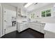 Bright white kitchen with stainless steel appliances and contrasting black floors at 508 Hastings Dr, Peachtree City, GA 30269