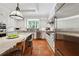 Bright kitchen with white cabinets, stainless steel appliances, island seating, and terra cotta tile floors at 508 Hastings Dr, Peachtree City, GA 30269