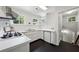 Cozy kitchen featuring black floors, white cabinetry and countertops, and gas range at 508 Hastings Dr, Peachtree City, GA 30269