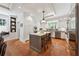 Bright kitchen with stainless appliances, white cabinets, terracotta floors, and a center island at 508 Hastings Dr, Peachtree City, GA 30269