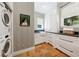A modern laundry room with white cabinets at 508 Hastings Dr, Peachtree City, GA 30269