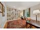 Cozy library with built-in bookshelves, rich wood accents, and a patterned area rug at 508 Hastings Dr, Peachtree City, GA 30269