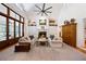 Spacious living room with a fireplace, built-in shelving, high ceilings and a large fan at 508 Hastings Dr, Peachtree City, GA 30269