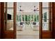 Sunroom featuring plentiful natural light with comfortable white seating, hardwood floors, and multiple ceiling fans at 508 Hastings Dr, Peachtree City, GA 30269