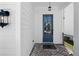 Inviting entryway with brick flooring, decorative light fixture, and blue front door at 627 Skytop Dr, Cumming, GA 30040