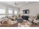 Well-lit living room with hardwood floors, comfortable seating, and a large flat-screen television at 627 Skytop Dr, Cumming, GA 30040