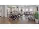 Open-concept living area with modern kitchen, cozy seating, and natural light from large windows at 627 Skytop Dr, Cumming, GA 30040