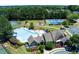 Aerial view of community pool, tennis courts, clubhouse and playground in a wooded setting at 1239 Side Step Trace, Lawrenceville, GA 30045