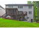 Rear exterior of home shows multi-level deck, patio, and lush green lawn at 1239 Side Step Trace, Lawrenceville, GA 30045