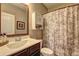 Nicely appointed bathroom featuring a tub/shower with a patterned curtain at 1239 Side Step Trace, Lawrenceville, GA 30045