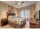 Comfortable bedroom featuring a ceiling fan, cozy decor, and soft natural light at 1239 Side Step Trace, Lawrenceville, GA 30045