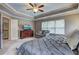 Bright spacious bedroom featuring tray ceiling, windows, and dresser at 1239 Side Step Trace, Lawrenceville, GA 30045