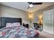 Cozy bedroom is furnished with a dark wood desk and ceiling fan at 1239 Side Step Trace, Lawrenceville, GA 30045
