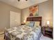 Comfortable bedroom featuring a double door closet and colorful floral art at 1239 Side Step Trace, Lawrenceville, GA 30045