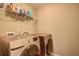 Bright laundry room featuring modern appliances and ample storage shelves for organization at 1239 Side Step Trace, Lawrenceville, GA 30045