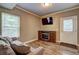 Cozy living room featuring a television, a sofa, and an outside entrance at 1239 Side Step Trace, Lawrenceville, GA 30045