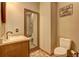 Stylish powder room with cream walls, ornate mirror, and a sign that says 