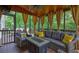 Screened-in porch features comfortable seating, a wood ceiling and view of the wooded backyard at 1239 Side Step Trace, Lawrenceville, GA 30045