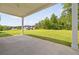 A back porch showcases views of a lush green yard and white farmhouse at 158 Palisade Dr, Rydal, GA 30171