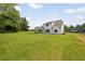 A sprawling backyard boasts lush green grass and a gorgeous white home at 158 Palisade Dr, Rydal, GA 30171