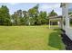 A large, green backyard features newly planted landscaping and a modern farmhouse at 158 Palisade Dr, Rydal, GA 30171
