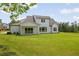 Expansive backyard featuring a well-maintained lawn and a covered patio with sliding glass doors for seamless indoor-outdoor living at 158 Palisade Dr, Rydal, GA 30171