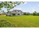 A gorgeous green backyard features a covered porch and mountain views at 158 Palisade Dr, Rydal, GA 30171