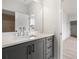 Modern bathroom featuring gray cabinets, a white countertop and large mirror at 158 Palisade Dr, Rydal, GA 30171
