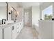 Elegant bathroom with double sink vanity, marble floors, modern fixtures, soaking tub and bright window at 158 Palisade Dr, Rydal, GA 30171