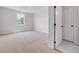 An empty bedroom features plush carpeting and a bright window at 158 Palisade Dr, Rydal, GA 30171