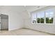 Bright bedroom with neutral carpet, a large window with backyard view and an angled ceiling at 158 Palisade Dr, Rydal, GA 30171