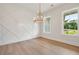Stylish dining room featuring a modern chandelier and custom wall details at 158 Palisade Dr, Rydal, GA 30171