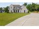 Stunning two-story home featuring a manicured lawn and long driveway at 158 Palisade Dr, Rydal, GA 30171