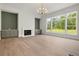 Spacious living room featuring a fireplace with custom built-ins and expansive windows overlooking the backyard at 158 Palisade Dr, Rydal, GA 30171