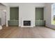 Bright living room with a fireplace, custom built-ins, and large windows for plenty of natural light at 158 Palisade Dr, Rydal, GA 30171