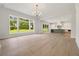 Spacious living room with hardwood floors and a kitchen view at 158 Palisade Dr, Rydal, GA 30171