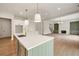 View of the open concept kitchen and living room space featuring a fireplace and custom built-ins at 158 Palisade Dr, Rydal, GA 30171