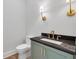 Powder room with dark granite countertop, a modern faucet, and stylish wall sconces at 158 Palisade Dr, Rydal, GA 30171