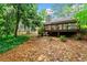 Private backyard featuring a deck overlooking lush, mature trees at 845 Creek Trail Northwest Nw Trl, Kennesaw, GA 30144