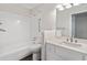 Bathroom features a shower over tub, with a white tile surround and a modern vanity at 845 Creek Trail Northwest Nw Trl, Kennesaw, GA 30144