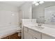 Bright bathroom features a shower over tub, with a white tile surround and modern vanity at 845 Creek Trail Northwest Nw Trl, Kennesaw, GA 30144