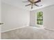 Spacious bedroom with neutral carpet and a window overlooking the wooded backyard at 845 Creek Trail Northwest Nw Trl, Kennesaw, GA 30144